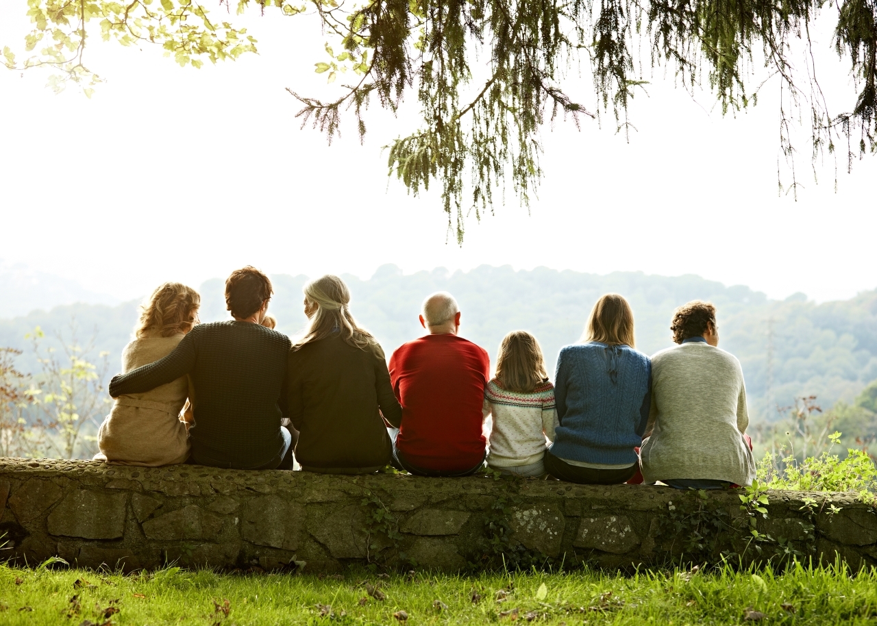 family group shot from behind looking at a lake